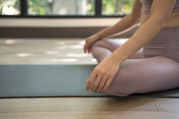 Female happiness Attractive young asian woman doing yoga stretching exercise on mat yoga & fitness exercises. Healthy lifestyle Calmness and relax