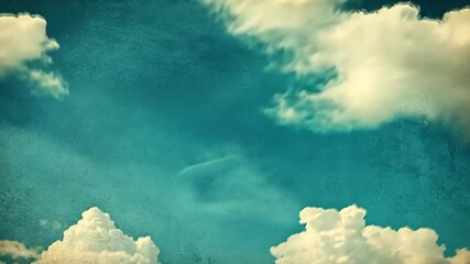 Wall Mural - White clouds drift across a blue sky on a sunny day