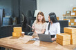 © NanSan - Two Asian business woman work at desk, selling fashion clothes online. They are packing checking items, ready to send to customers. Their clear business planning ensures success in sales marketing
