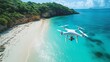 © Budi - A drone flying over a pristine beach with turquoise waters and lush greenery.
