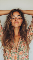 Wall Mural - Young woman in a floral top with her hands behind her head.