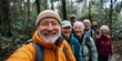 © Rahul - Nature, selfie and senior friends hiking together in a forest while on an outdoor adventure. Happy, smile and portrait of a group of elderly people trekking in woods for wellness, Generative AI