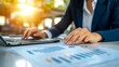 © top images - Business professional analyzes financial data while working on a laptop in a well-lit office during the afternoon