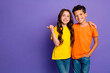 © deagreez - Photo of charming two little children hugging point empty space wear trendy orange yellow outfit isolated on violet color background