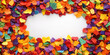 © Iswanto - Colorful confetti-like petals frame a blank space for text or design.