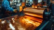 © Old Man Stocker - Worker operates a copper foil roll machine in a manufacturing facility, showcasing the precision and technology involved in metal processing and production.