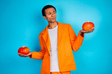 Sticker - Photo of guy holding thanksgiving day pumpkin vegetables look thinking hesitate isolated blue color background