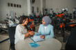 © Odua Images - young woman and saleswoman in hijab chat and shake hands when agrees to buy a new motorcycle at a showroom