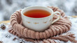 © xeionise - Cozy Winter Tea in a Knit Scarf on a Snowy Day..