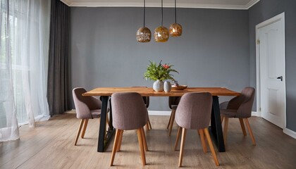 Modern and stylish dining room interior with glamour wooden table , elegant chairs and design decoration. Template. Home decor. Gray background wall.