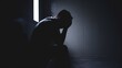 © THESUN - Silhouette of a man holding his head in a prison cellConcept of freedom