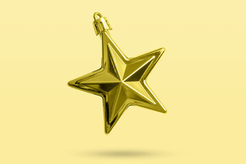Wall Mural - Golden Christmas star ornament bauble isolated on yellow background