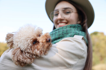 Canvas Print - Smiling woman with her cute dog outdoors