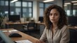 © KLSHKA - A young, self-assured woman with soft facial features, smooth brown skin, and curly dark brown hair, sitting casually in a modern office setting
