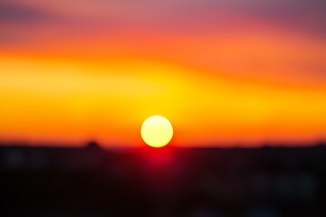 Sunset autumn blurred abstract nature background image showing a golden yellow and brown autumn landscape.