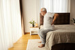 © Dusan Petkovic - Senior man with backache trying to get up from the bed in the morning.