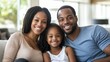 © CStock - A father, mother, and daughter sitting together on a couch, smiling warmly at the camera, showcasing a close family bond in a modern living room Close-up photo with clean background