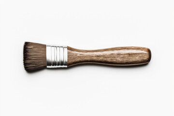 Close-up of a flat paint brush with a wooden handle and metal ferrule, isolated on a white background.