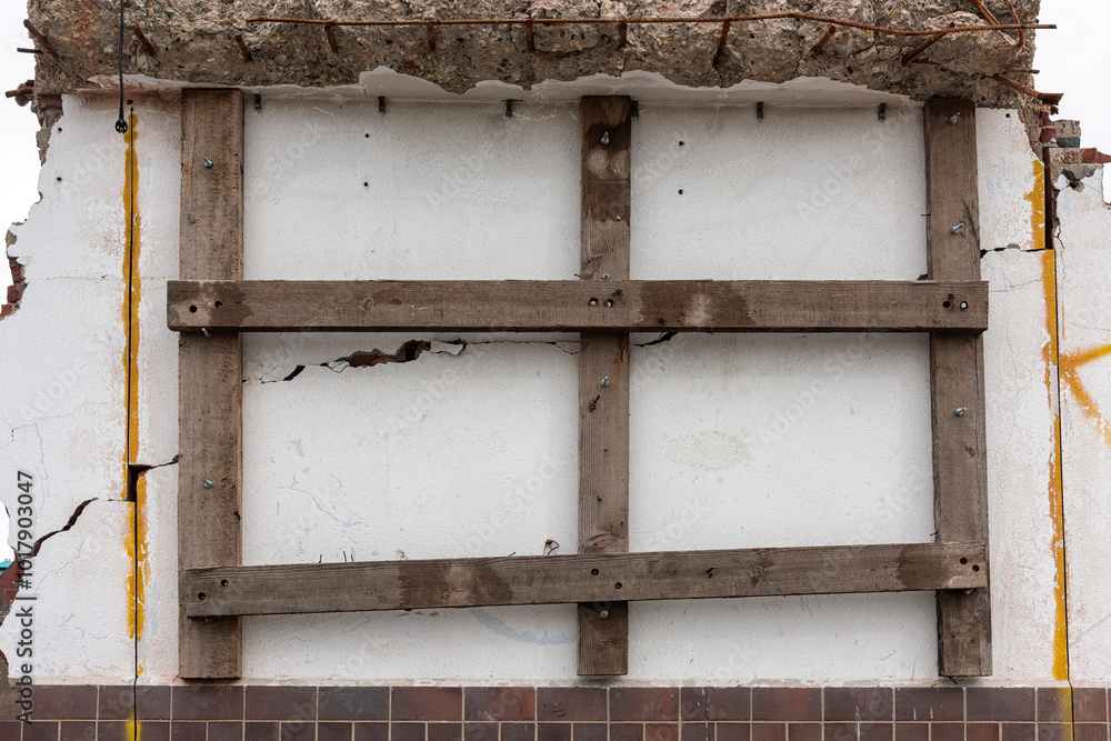 wooden beams attached to a demolished plaster wall