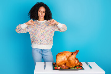 Canvas Print - Photo portrait of attractive young woman thumb down disapprove celebrate thanksgiving dinner turkey isolated on blue color background