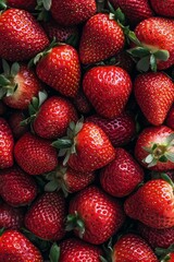 Freshly harvested strawberries piled together in vibrant red hues ready for summer recipes