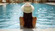 © Siasart Studio - A woman relaxes by a pool, enjoying a tranquil summer day.