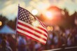 © Victor Bertrand - Bathed in sunset glow, a lone American flag waves at a festive gathering, evoking warmth and patriotism.