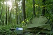© Victor Bertrand - A green tent and solar panel bask in a sun-dappled forest, blending technology with nature's tranquility.