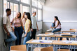 © Xavier Lorenzo - Diverse young high school students hanging out in classroom during break. Education concept