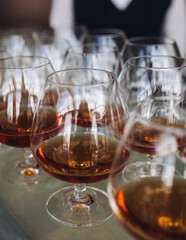 Wall Mural - Alcohol setting on catering banquet table, bartender pouring liquor beverages, row line of different colored alcohol drinks on a party, glass of wine, sparkling wine on decorated banquet table event