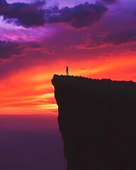 Canvas Print - Silhouetted Person Standing on Dramatic Cliff Sunset Sky Landscape