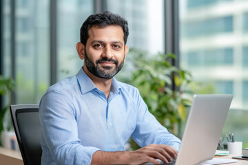 young indian businessman working on laptop