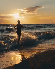 Poster - Silhouetted Person Running Along a Dramatic Sunset Beach