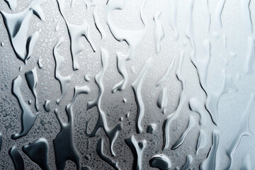 Canvas Print - Close-up of condensation water drops on a smooth glass surface, creating intricate and abstract patterns with variations in light and transparency.