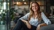 © yusufadi - Smiling Woman Sitting in a Modern Office