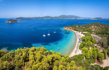 Wall Mural - panoramic aerial view of the beach at tsougrias island with the bay and town of skiathos, sporades, 