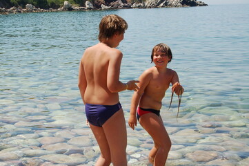 children brothers on beach