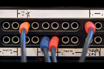 Fragment of connections between cables on sound table in sound studio