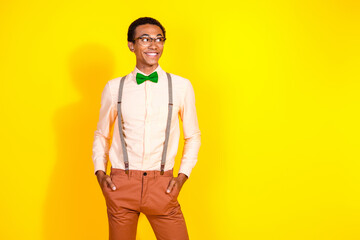 Canvas Print - Photo of elegant young man look empty space wear shirt bow tie isolated on yellow color background