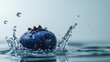 © Theeranan - Blueberry hitting water, creating a dynamic splash effect with droplets in mid-air, against a clean background