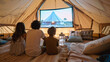 © INT888 - Family enjoying portable projector movie night inside cozy tent, creating warm and memorable experience together.