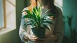 © Mr image - 49. A model holding a beautiful plant in a well-lit room