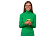 © Damir Khabirov - Portrait of woman in green using phone wearing stylish glasses