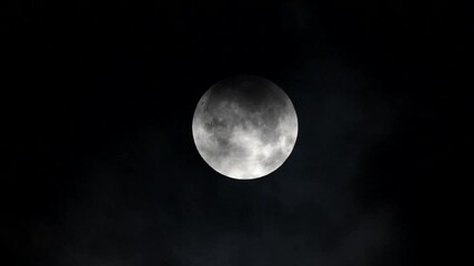 Wall Mural - Partial lunar eclipse Full moon and lunar eclipse Full moon between the clouds Super moon 2024