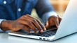© KN Studio - Focused Hands Typing on Laptop