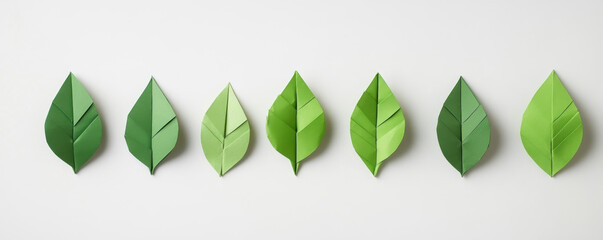 green paper origami leaves arranged in a row banner