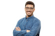 Young businessman wearing casual denim blue shirt and glasses, looking at camera with positive confident smile, holding arms crossed