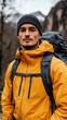© Creative Stock Ai - man hiking in the mountains, with yellow jacket and backpack