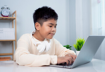 educational of tech concept, staying at home, little asian boy student using computer laptop learnin