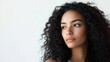 © Bijac - young brazilian woman with curly hair gazing thoughtfully sideways, soft natural lighting, minimalist white background enhancing her features and expression.